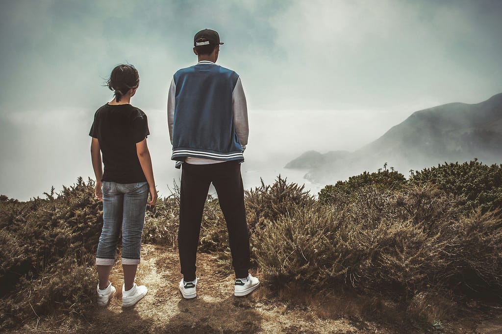 man and woman standing on mountain during day - ADHD in Women vs Men