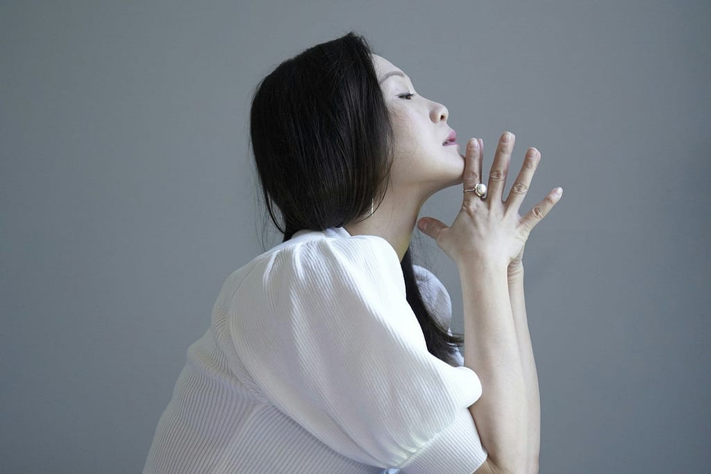 woman in white knit sweater - adhd and menopause