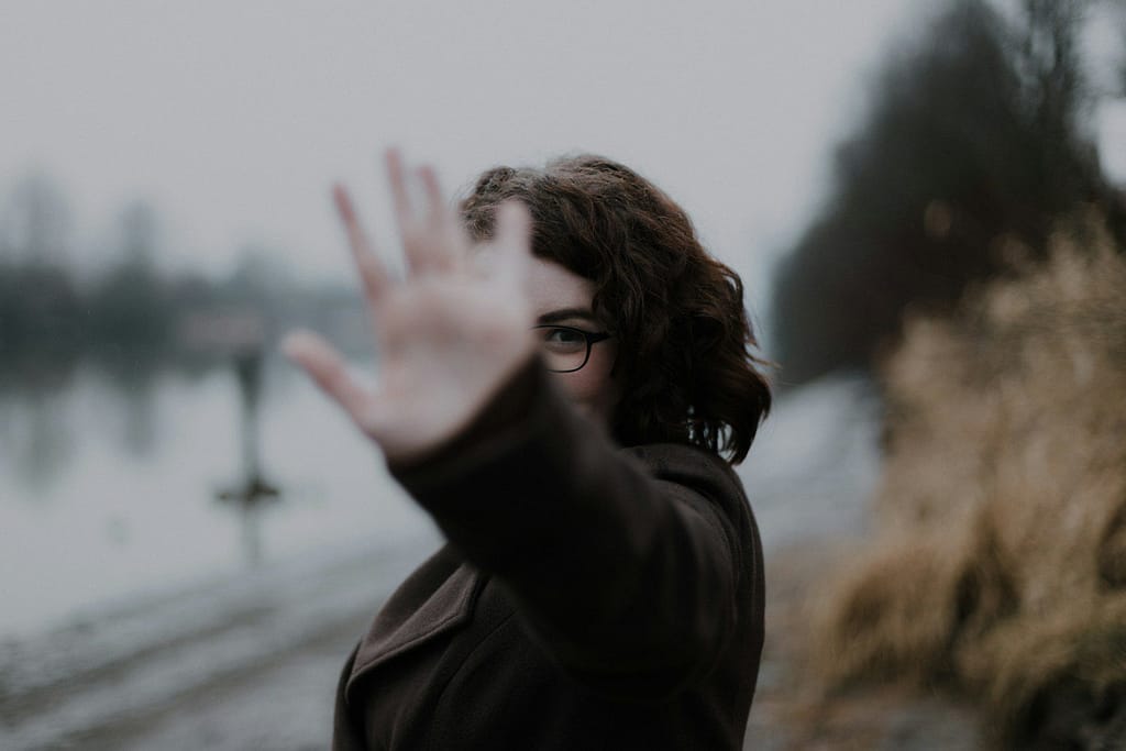 woman in black coat standing near body of water during daytime PMDD and ADHD
