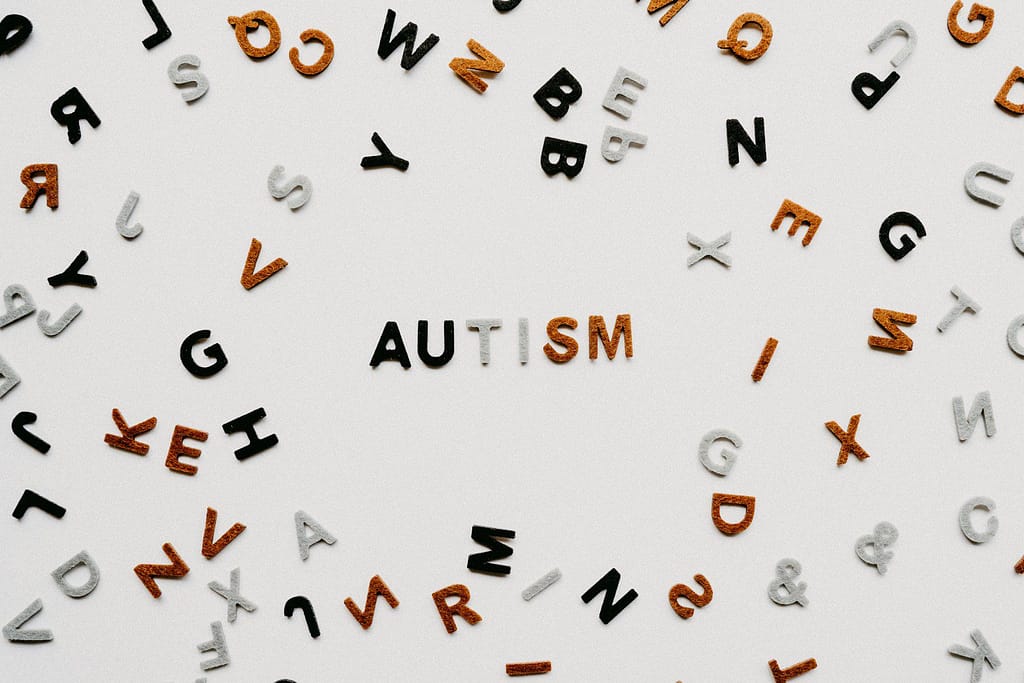 a group of letters on a white surface - Autism Symptoms in Adults Checklist