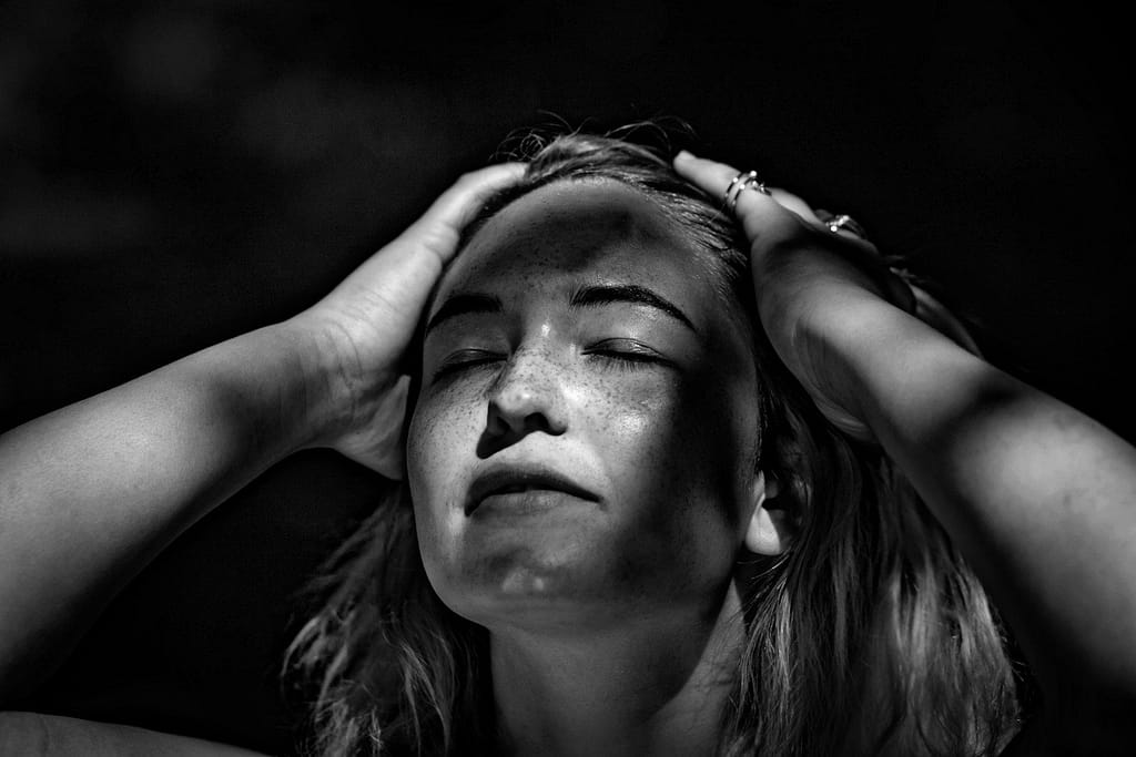 grayscale photography of woman holding her head - adhd regulating emotions