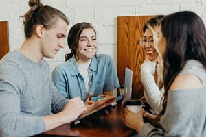 Group of friends discussing over coffee together - Philanthropeak Coaching A group of friends at a coffee shop - How Does ADHD Affect Relationships