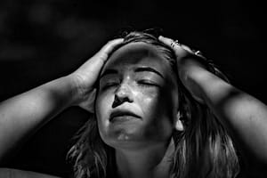 grayscale photography of woman holding her head - adhd regulating emotions